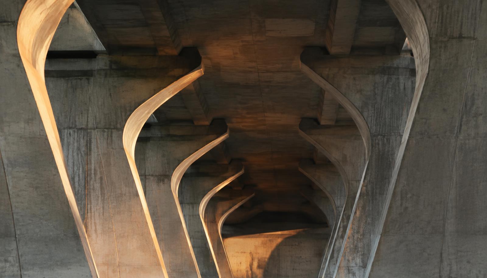 Infrastructure detail: steel and concrete span in low natural light